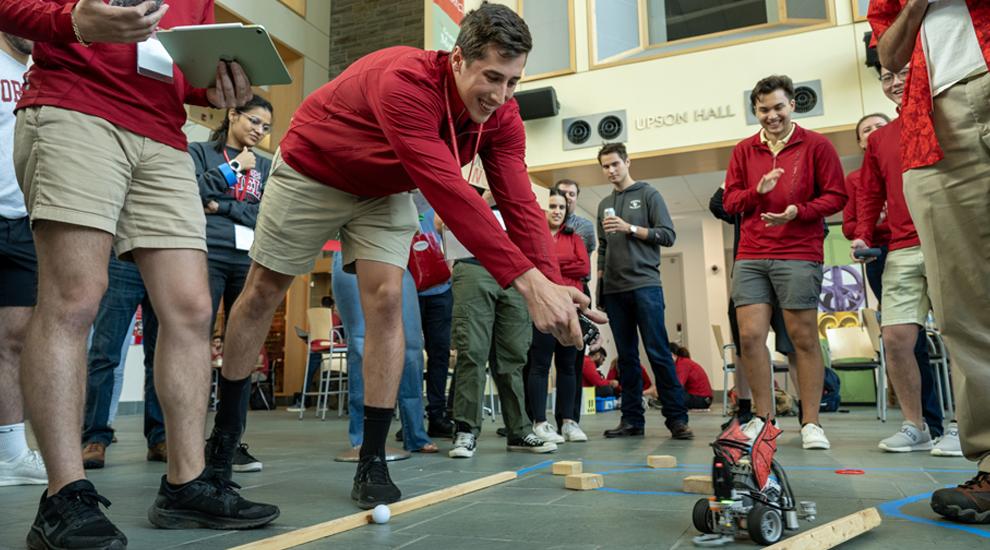 A student powers his robot in the robotic competition