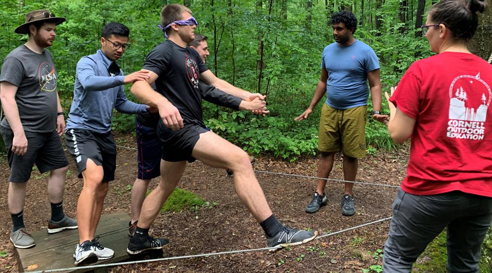 A student does a blindfolded exercise on the Hoffman Challenge Course